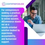 A smiling man working on a laptop in a modern office.